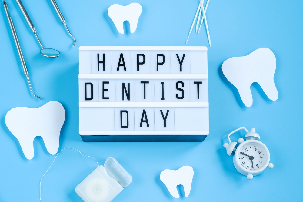 Happy International Dentist Day. Paper cut mockup of tooth and dental tool on blue background. Dental care concept. Greeting card for professional holiday. Copy space.