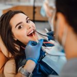 a woman is getting dental treatment